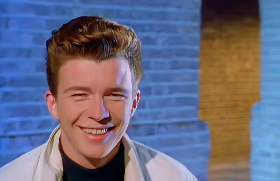 Rick Astley Smiling in his Classic Rick Roll Video, Never Gonna Give You Up