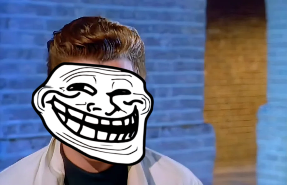 Rick Astley with a troll meme face, probably after he Rick Rolled someone